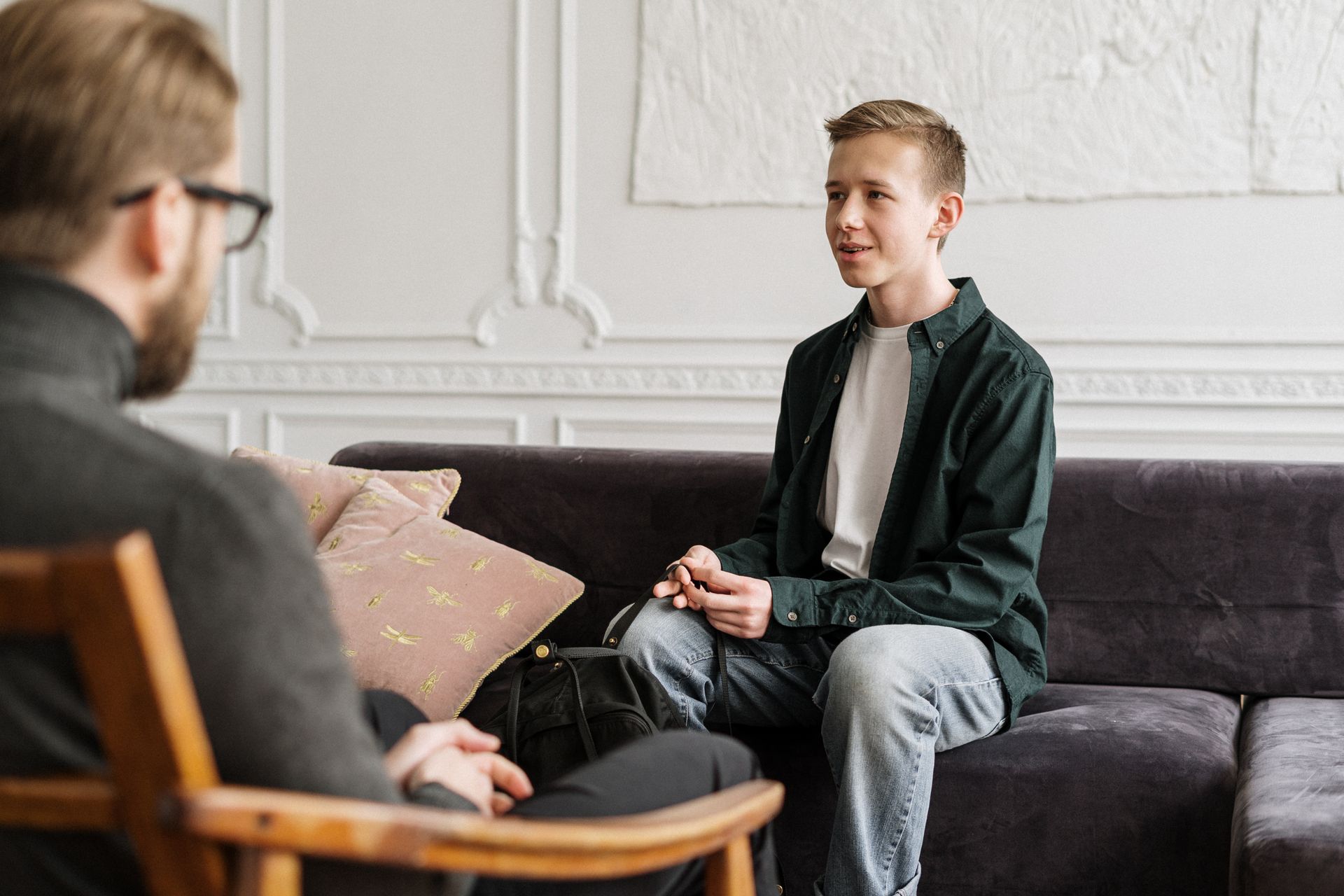 A young person speaking with a supportive mentor